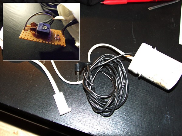 The finished wiretap circuit, placed into an enclosure. Inset image shows circuit inside.